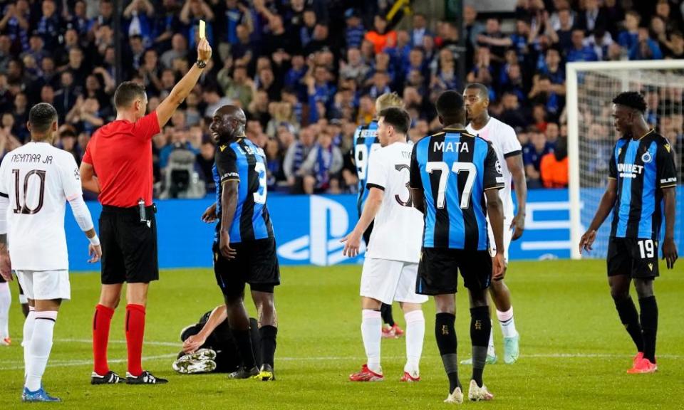 Lionel Messi is booked during PSG’s 1-1 draw at Club Brugge