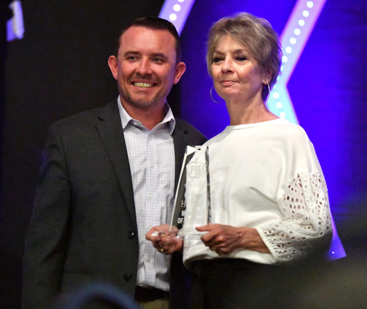 Clydette Holcomb, right, wins the Mentor of the Year award during the PIE appreciation dinner at Faith Baptist Church in Wichita Falls on Tuesday. Dr. Donny Lee, Wichita Falls ISD superintendent, presents the award.