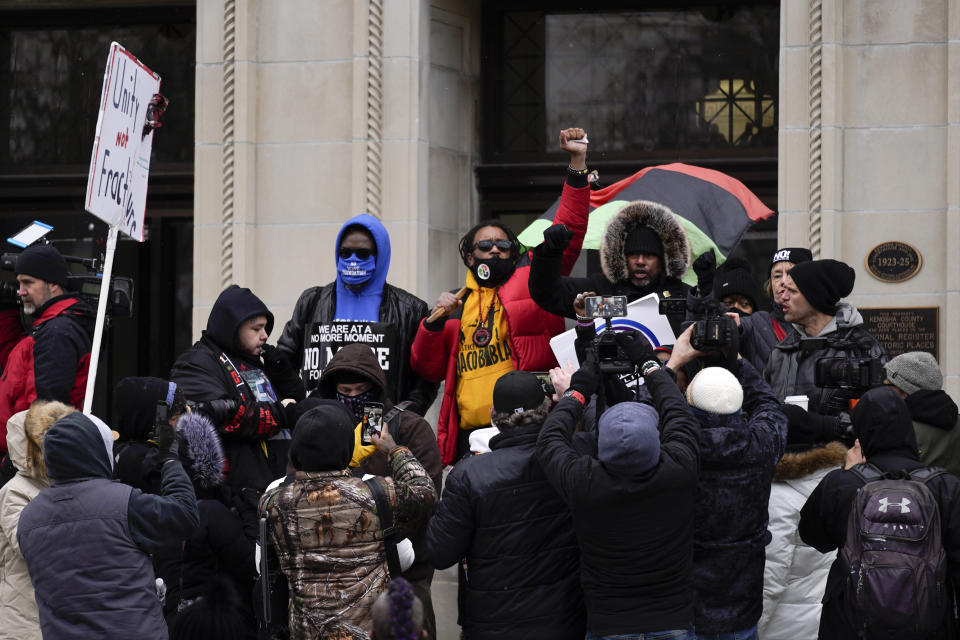 Justin Blake, uncle of Jacob Blake, raises his fist outside the Kenosha County Courthouse, Thursday, Nov. 18, 2021 in Kenosha, Wis., during the Kyle Rittenhouse murder trial. Rittenhouse is accused of killing two people and wounding a third during a protest over police brutality in Kenosha, last year. (AP Photo/Paul Sancya)