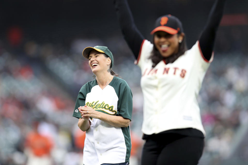 The mayor of Oakland Libby Schaff, left, and the mayor of San Francisco London Breed, smile after throwing out the first pitch before the San Francisco Giants and the Oakland Athletics baseball game in San Francisco, Friday, June 25, 2021. (AP Photo/Jed Jacobsohn)