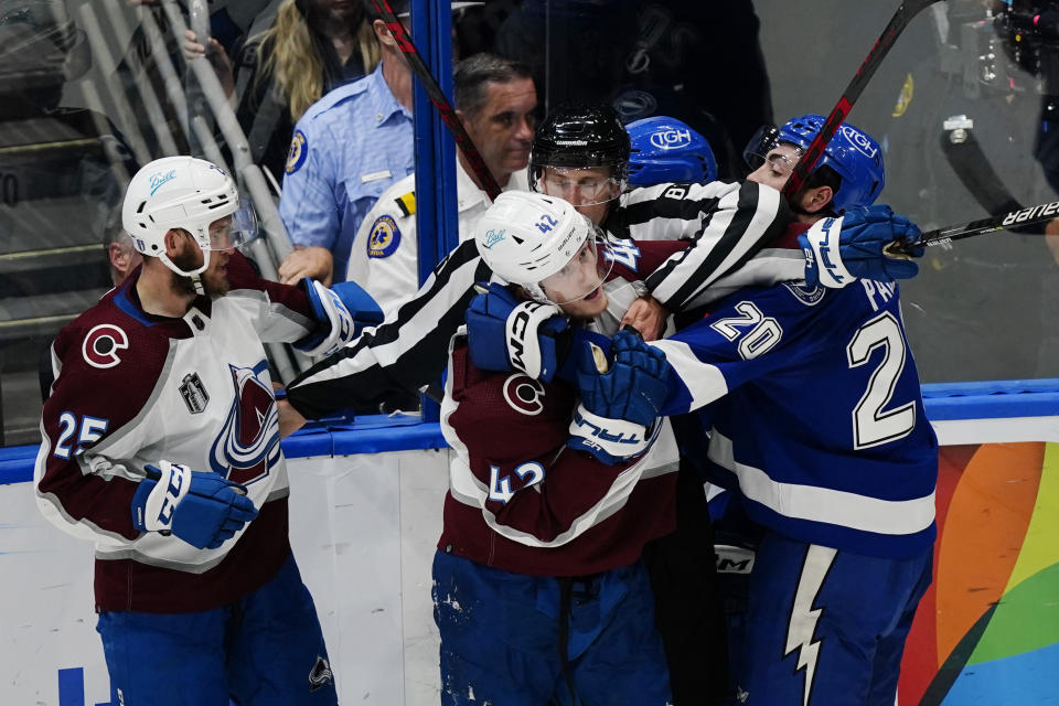 Linesman Ryan Daisy separates Colorado Avalanche defenseman Josh Manson (42) and Tampa Bay Lightning left wing Nicholas Paul (20) during the first period of Game 6 of the NHL hockey Stanley Cup Finals on Sunday, June 26, 2022, in Tampa, Fla. (AP Photo/John Bazemore)