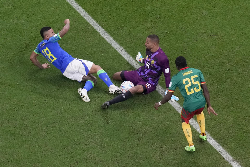 Cameroon's goalkeeper Devis Epassy makes a save in front of Brazil's Gabriel Jesus, left, during the World Cup group G soccer match between Cameroon and Brazil, at the Lusail Stadium in Lusail, Qatar, Friday, Dec. 2, 2022. (AP Photo/Thanassis Stavrakis)