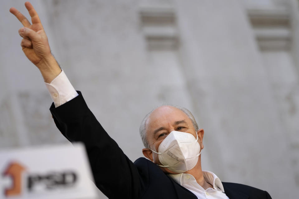 Rui Rio, leader of the center-right Social Democratic Party, gestures while campaigning in downtown Lisbon, Friday, Jan. 28, 2022. Portuguese voters go to the polls Sunday, two years earlier than scheduled after a political crisis over a blocked spending bill brought down the country's minority Socialist government and triggered a snap election. (AP Photo/Armando Franca)