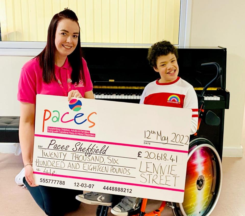 Lennie Street hands over the cash he has raised to Julie Booth, head of fundraising at Paces School, in Sheffield (Paces School/PA)