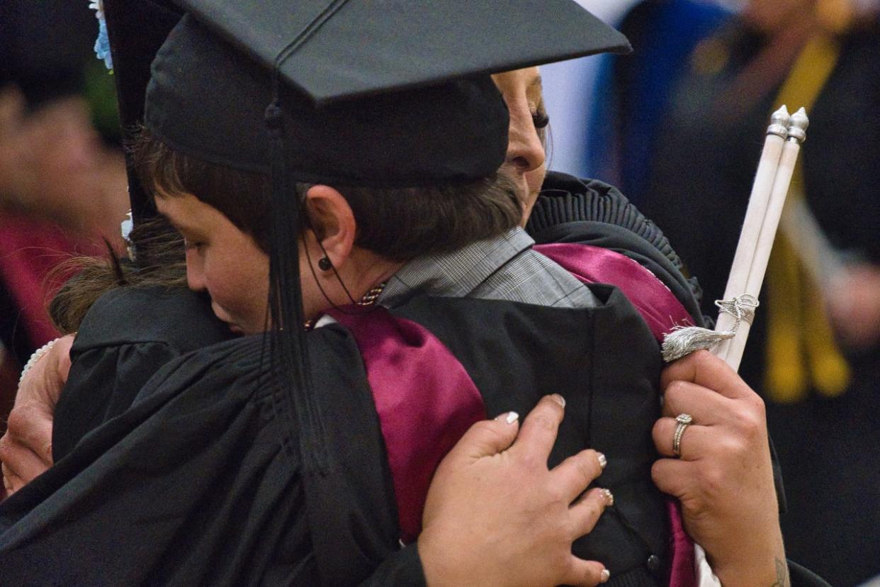 Jenna Bazzell, associate professor of English, congratulates one of the graduates at MCCC's 57th commencement ceremony.