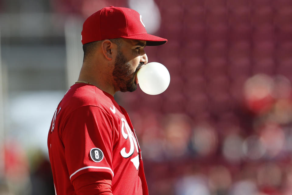 Cincinnati Reds' Eugenio Suarez blows a bubble while waiting for the next pitch against and Washington Nationals during the ninth inning of a baseball game Sunday, Sept. 26, 2021, in Cincinnati. The Reds defeated the Nationals 9-2. (AP Photo/Jay LaPrete)