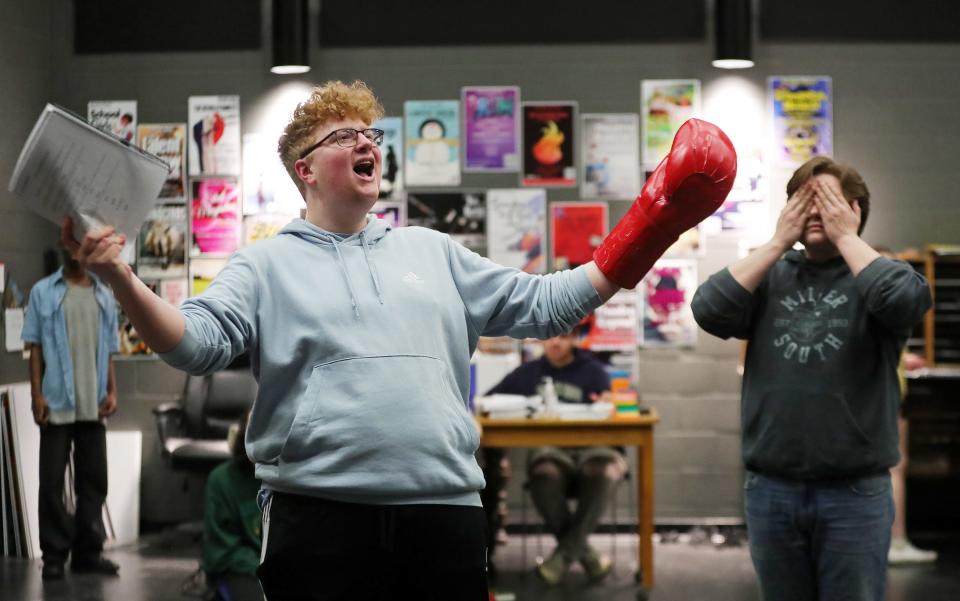 Junior Andy Rambler, who plays Mr. Krabs, left, practices his solo at rehearsal for "The SpongeBob Musical" at Firestone CLC.