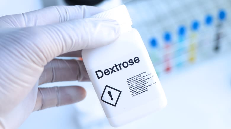 Holding bottle of dextrose