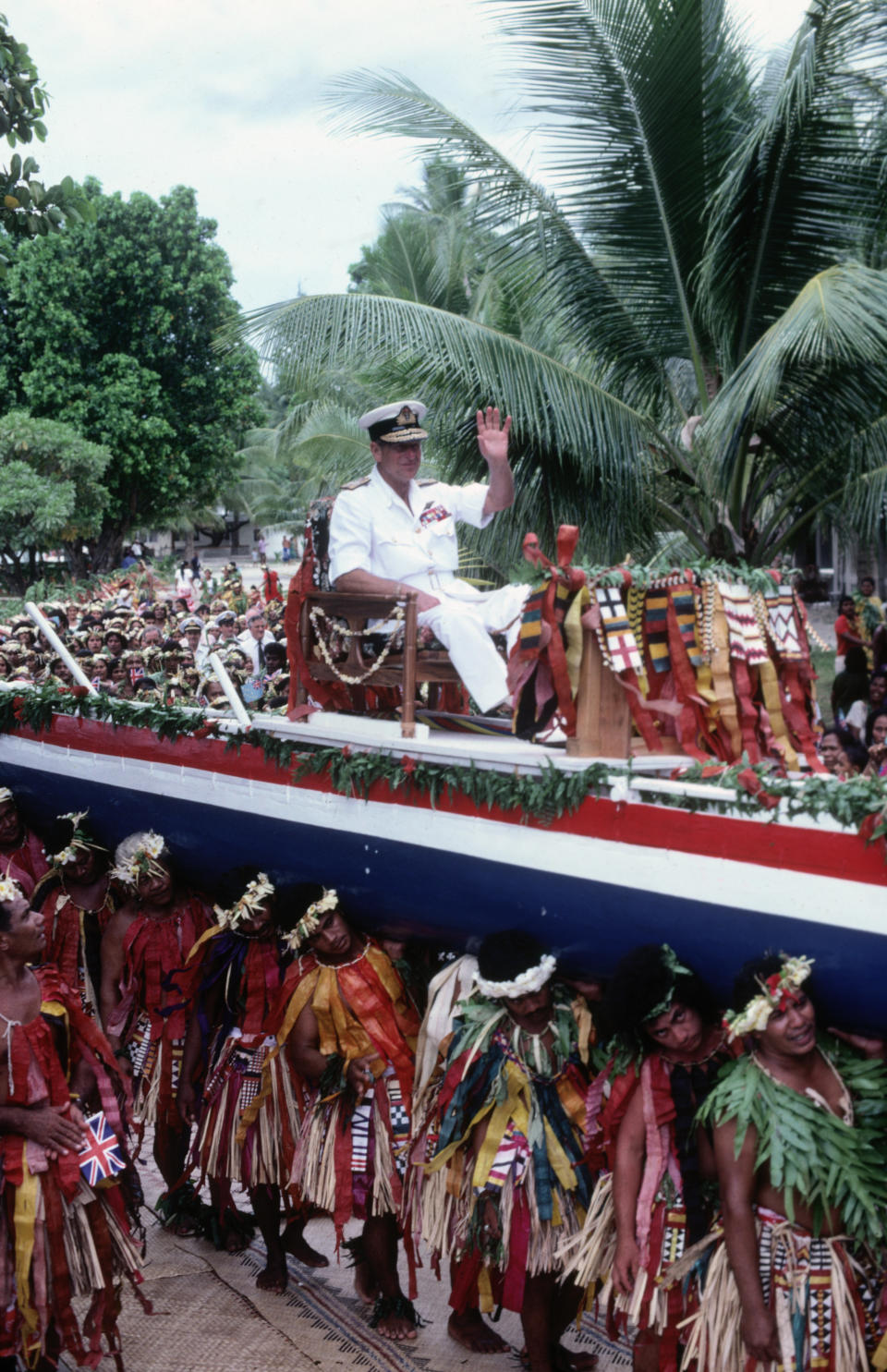 TUVALU - OCTOBER 26:  Prince Philip the Duke of Edinburgh is carried aloft on a canoe through the streets of the Pacific island of Tuvalu on October 26, 1982 during the Royal Tour of the South Pacific. (Photo by David Levenson/Getty Images)