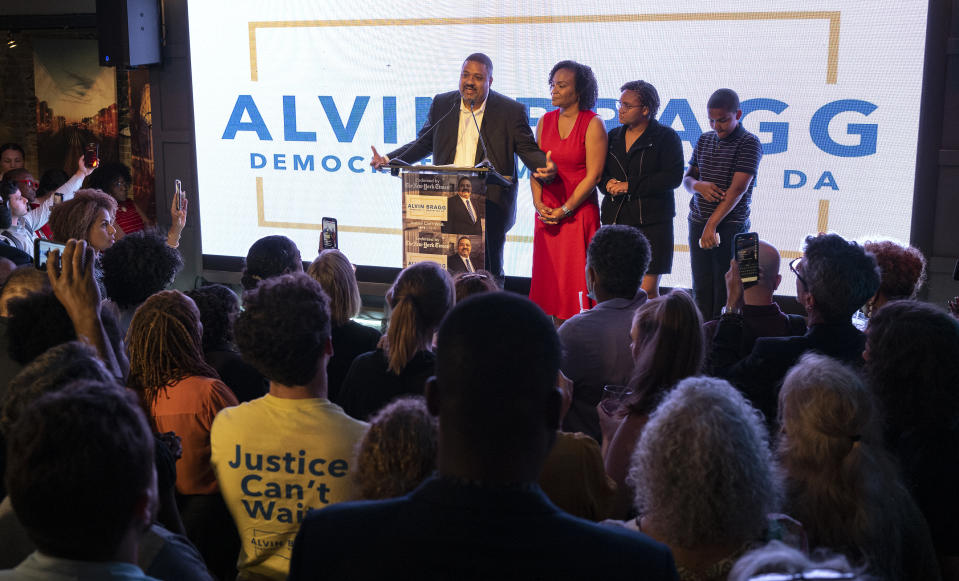 Alvin Bragg, a former top deputy to New York's attorney general, stands with his family as he speaks to supporters in New York, late Tuesday, June 22, 2021. (AP Photo/Craig Ruttle)
