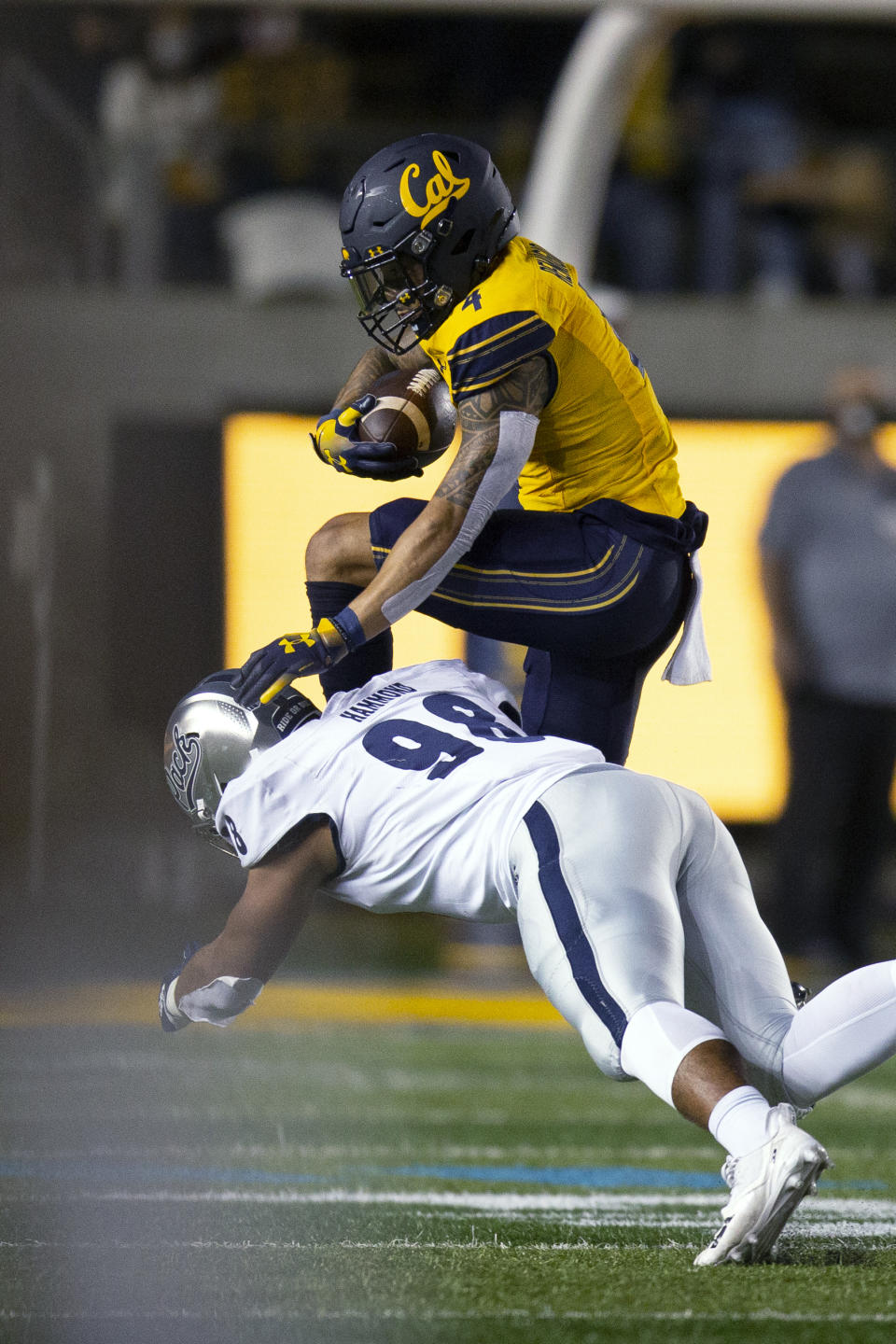 California wide receiver Nikko Remigio (4) hurdles Nevada defensive end Sam Hammond (98) during the first quarter of an NCAA college football game Saturday, Sept. 4, 2021, in Berkeley, Calif. (AP Photo/D. Ross Cameron)