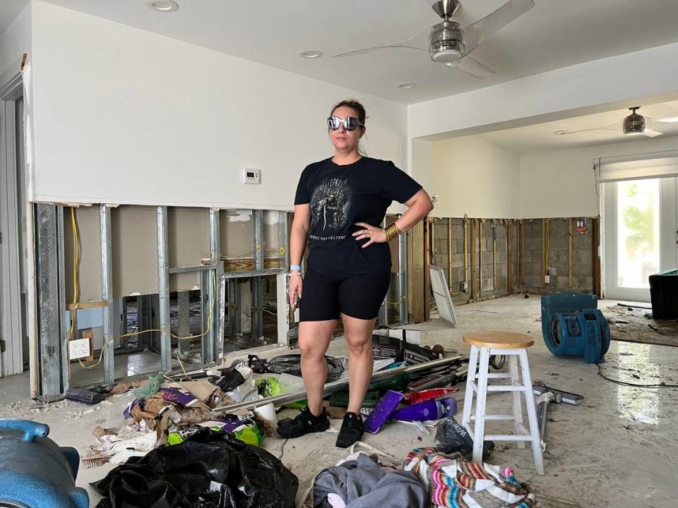 Renee Longini, a nurse anesthetist, stands in her Fort Lauderdale living room, which saw three feet of floodwater during the rainstorm. Longini said it could take four to six months to repair her home. Alex Harris/aharris@miamiherald.com