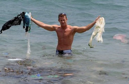 A conservationist collects plastic from the water at a Hong Kong beach. The UK-based Plastic Oceans Foundation says at least 250 species have ingested or become entangled in plastic in the seas. They put forward plastic ingestion as one of the main causes of "skinny whale syndrome", in which whales are discovered mysteriously starved