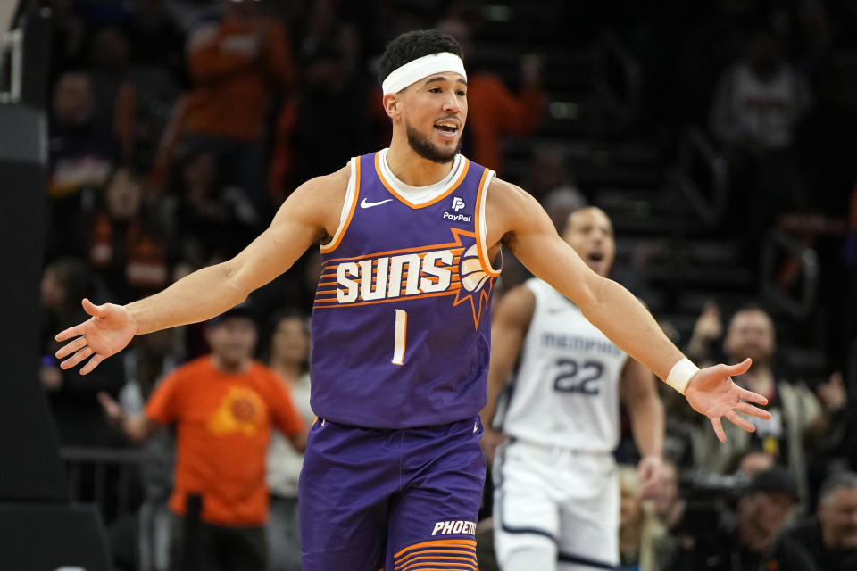 Phoenix Suns guard Devin Booker (1) reacts after scoring against the Memphis Grizzlies during the second half of an NBA basketball game, Sunday, Jan. 7, 2024, in Phoenix. (AP Photo/Rick Scuteri)