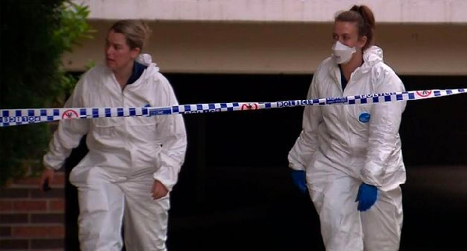 Two forensic workers are seen at the unit of Sabah Hafiz, who was allegedly bashed to death at her Wentworthville unit on Wednesday morning.