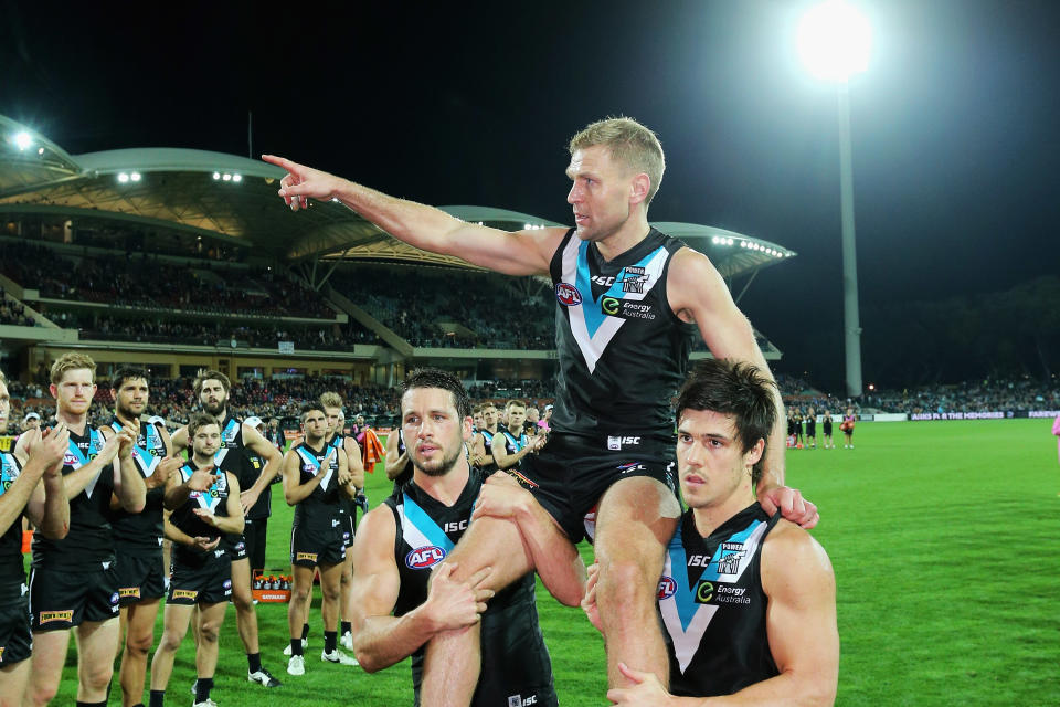 ADELAIDE, AUSTRALIA - MAY 24: Kane Cornes of the Power is carried off the field by Travis Boak of the Power and Angus Monfries of the Power after his 300th and final game during the round eight AFL match between the Port Adelaide Power and the Richmond Tigers at Adelaide Oval on May 24, 2015 in Adelaide, Australia.  (Photo by Daniel Kalisz/Getty Images)