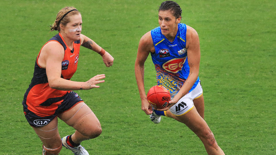 Jasmine Hewett, pictured here running with the ball against Greater Western Sydney Giants in the AFLW.