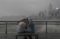 <p>People play with strong wind caused by Typhoon Hato on the waterfront of Victoria Habour in Hong Kong, Wednesday, Aug. 23, 2017. (Photo: Vincent Yu/AP) </p>