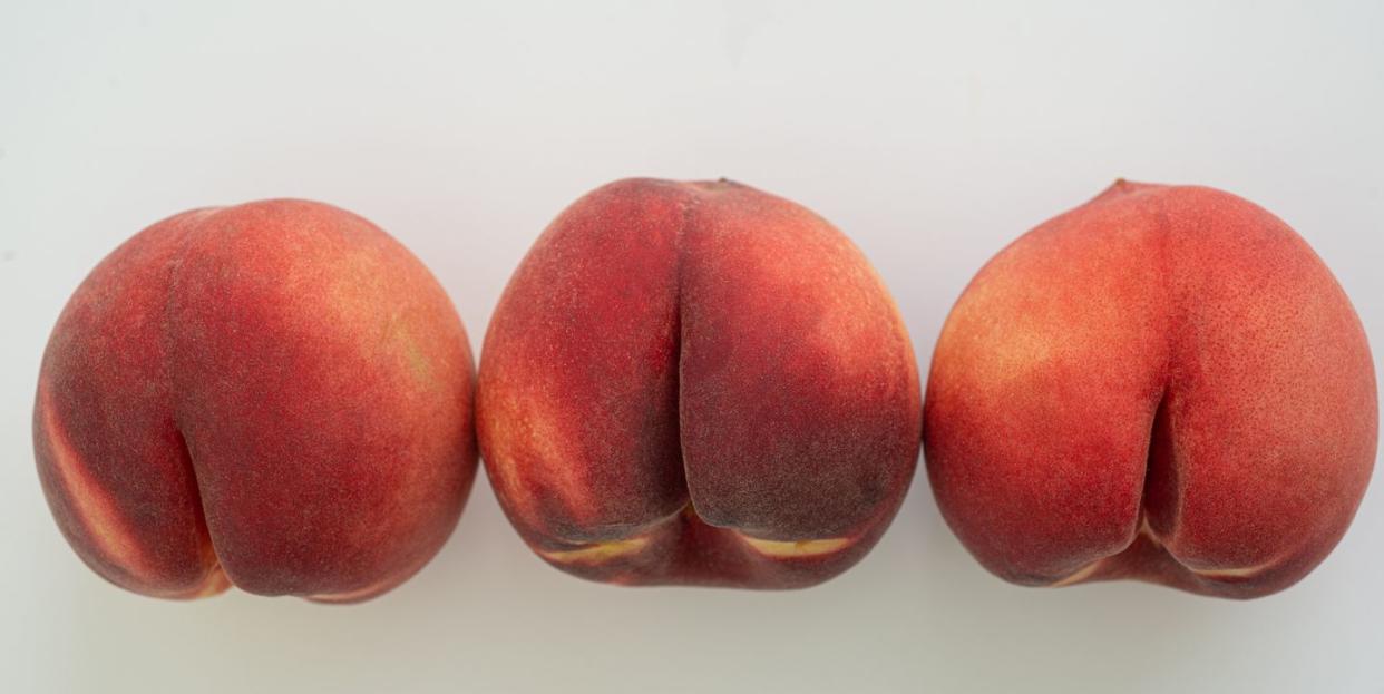 a row of white peaches on white surface