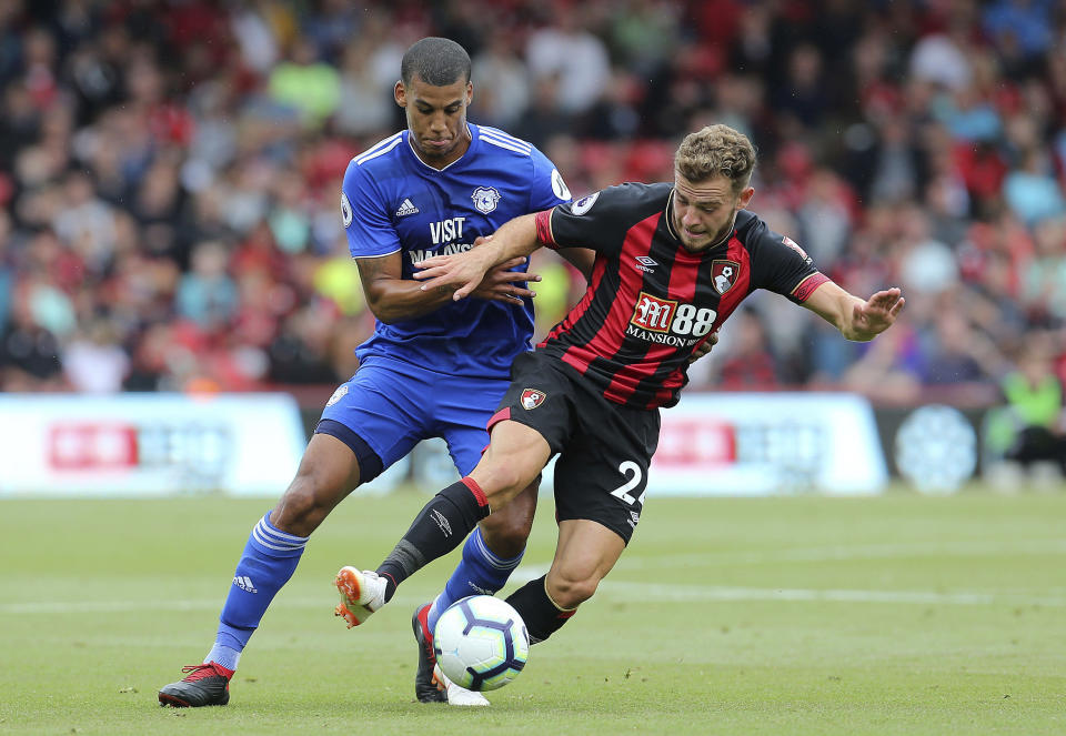 Cardiff City's Lee Peltier, left, and Bournemouth's Ryan Fraser in action during their English Premier League soccer match at the Vitality Stadium in Bournemouth, England, Saturday Aug. 11, 2018. (Mark Kerton/PA via AP)