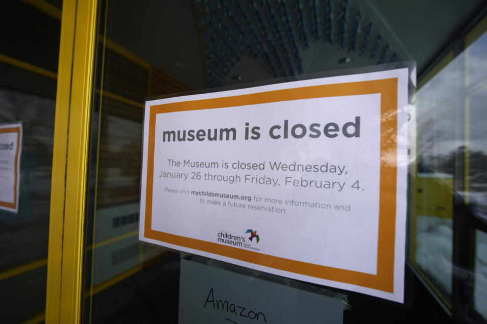 Sign hangs on the shuttered door of the Children's Museum of Denver at Marsico Campus Thursday, Jan. 27, 2022, in Denver. The popular museum temporarily closed on Wednesday because of escalating harassment of staff by adult visitors angry over a city-ordered mandate requiring anyone age 2 and older to wear a mask in indoor public spaces. The museum will remain closed until Friday, Feb. 4. (AP Photo/David Zalubowski)