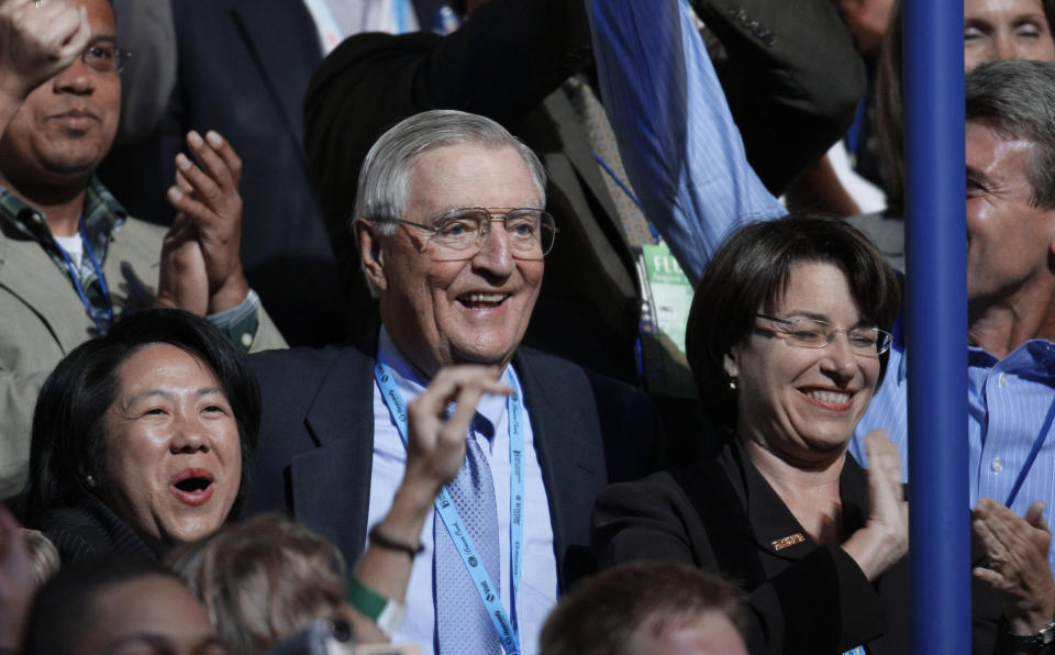 FILE - In this Wednesday, Aug. 27, 2008, file photo, former Vice President Walter Mondale, center, and Sen. Amy Klobuchar, D-Minn., right, are seen after announcing their presidential nominee during the roll call of states on the third day of the Democratic National Convention in Denver. Mondale, a liberal icon who lost the most lopsided presidential election after bluntly telling voters to expect a tax increase if he won, died Monday, April 19, 2021. He was 93. (AP Photo/Charlie Neibergall, File)
