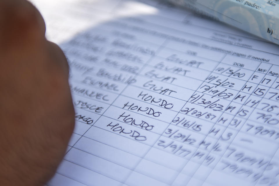 A Border Patrol agent collects information about a group of detained illegal immigrants. (Photo: Sergio Flores for Yahoo News)