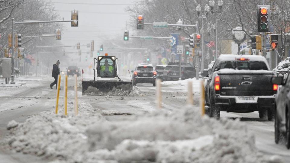 A worker helped make Armour Road in North Kansas City more passable after two to four inches fell in the Kansas City area Saturday, Jan. 15, 2022.