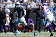 Carolina Panthers quarterback Sam Darnold (14) is pursued by Minnesota Vikings Everson Griffen (97) during the first half of an NFL football game, Sunday, Oct. 17, 2021, in Charlotte, N.C. (AP Photo/Jacob Kupferman)