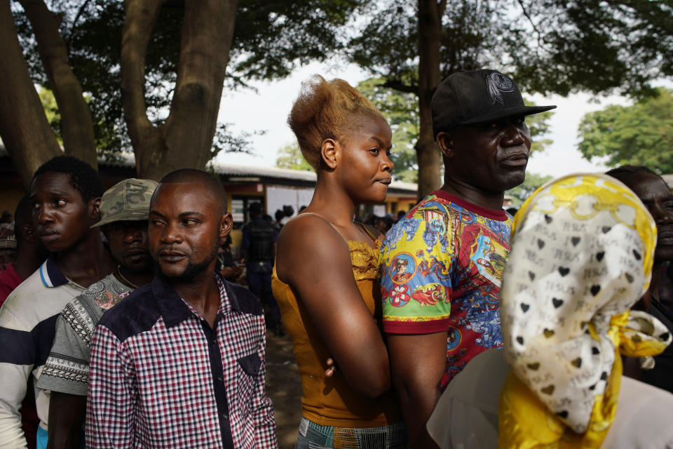 Congolese voters line up to vote in Kinshasa Sunday Dec. 30, 2018. Some forty million voters are registered for a presidential race plagued by years of delay and persistent rumors of lack of preparation. (AP Photo/Jerome Delay)