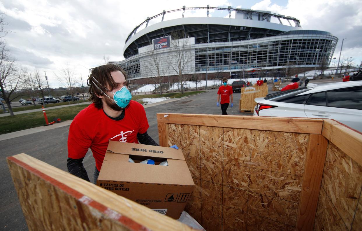 Ian Coulter, originally from Seattle who is studying at the University of Colorado Medical Center, moves medical supplies that were donated as part of an effort staged by two state lawmakers, Project C.U.R.E., Colorado Concern and the Denver Broncos with the spread of coronavirus on Sunday, March 22, 2020, in Denver.