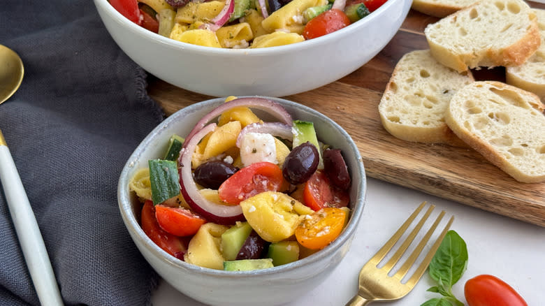 bowl of tortellini greek salad with fork and bread
