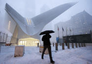 <p>A man makes his way through wind and snow past the Oculus of the World Trade Center Transportation Hub, Thursday, Feb. 9, 2017, in New York. A powerful, fast-moving storm swept through the northeastern U.S. Thursday, making for a slippery morning commute and leaving some residents bracing for blizzard conditions. (Photo: Mark Lennihan/AP) </p>