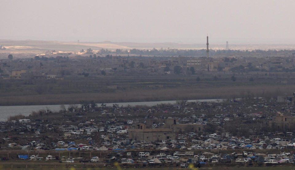 The Islamic State group's last pocket of territory in Baghouz, Syria, as seen from a distance on Sunday, March 17, 2019. U.S.-backers forces fighting to take back the last IS outpost in Syria said they are facing difficulties defeating the group. A spokesman says their effort is being slowed by mines, tunnels, and the possibility of harming women and children still in the village. (AP Photo/Maya Alleruzzo)