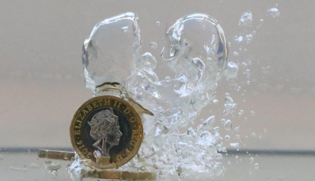 UK pound coins plunge into water in this illustration picture, October 26, 2017. Picture taken October 26, 2017. REUTERS/Dado Ruvic/Illustration