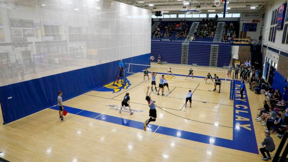 West Jessamine’s Zach Stowe, foreground, serves during the Colts’ match against Trinity in the KVCA boys’ volleyball state semifinals at Henry Clay on Wednesday.