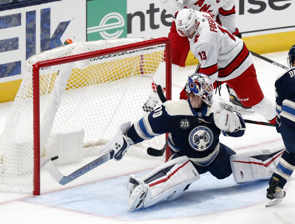 Carolina Hurricanes forward Warren Foegele, right, scores past Columbus Blue Jackets goalie Joonas Korpisalo during the second period of an NHL hockey game in Columbus, Ohio, Sunday, Feb. 7, 2021. (AP Photo/Paul Vernon)