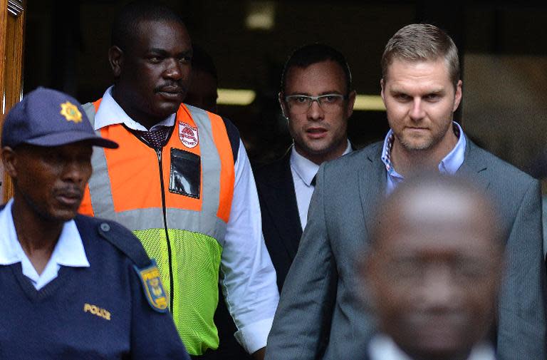 South African Paralympic track star Oscar Pistorius (C) leaves the North Gauteng High Court in Pretoria on April 17, 2014