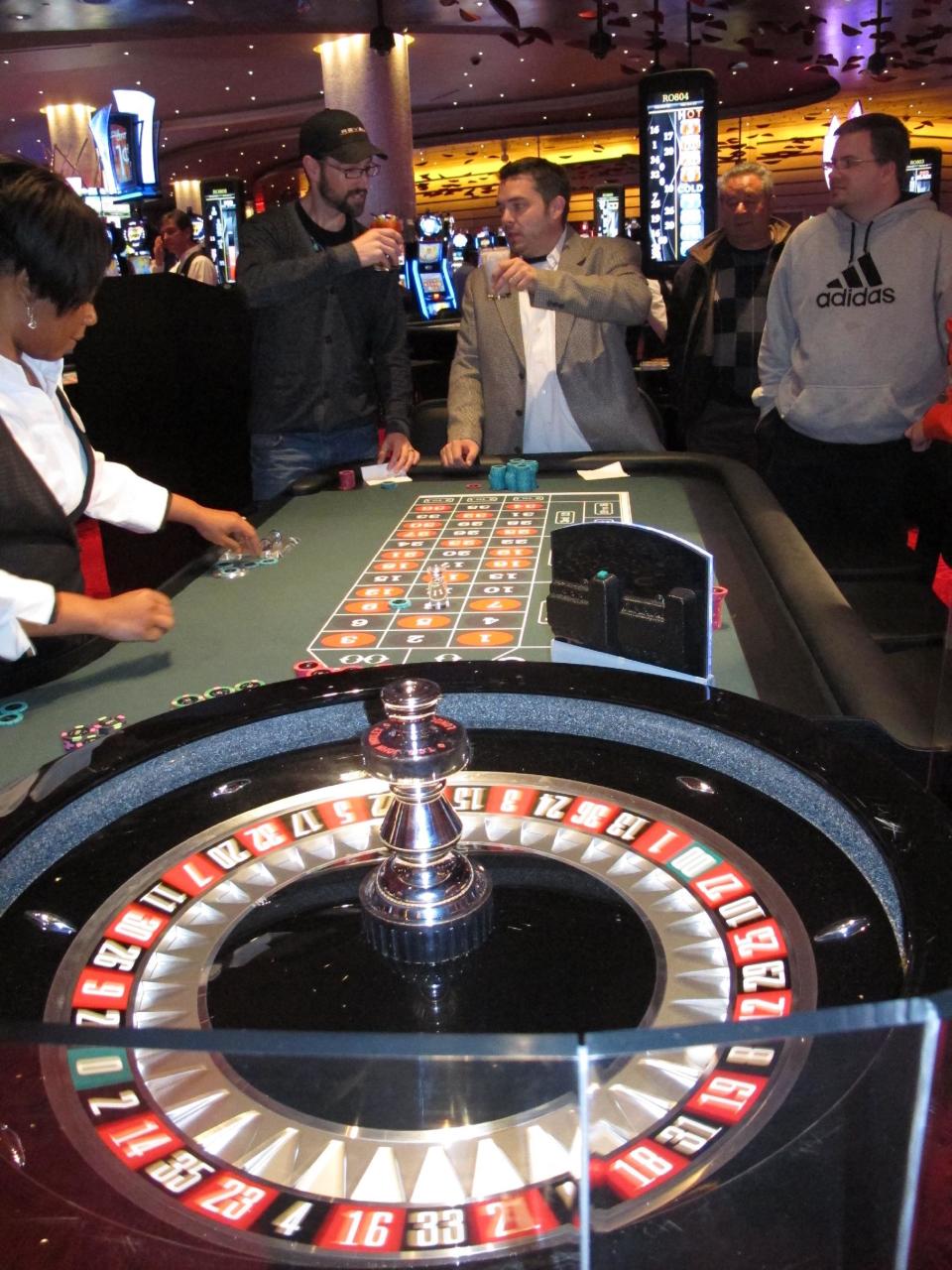 Keith Groff, left, and Jerry Colonna, right, toast each other after another winning spin at a roulette table at Revel, the $2.4 billion casino resort in Atlantic City, N.J., Monday, April 2, 2012. Colonna, the first customer through the doors when the casino opened at 7 a.m., walked away from the table up $1,500 after just 10 minutes of gambling. (AP Photo/Wayne Parry)