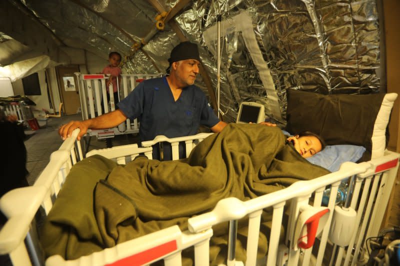 A Palestinian child injured by Israeli bombing is treated in a Emirati field hospital in Rafah in the southern Gaza Strip on Sunday. Photo by Ismael Mohamad/UPI