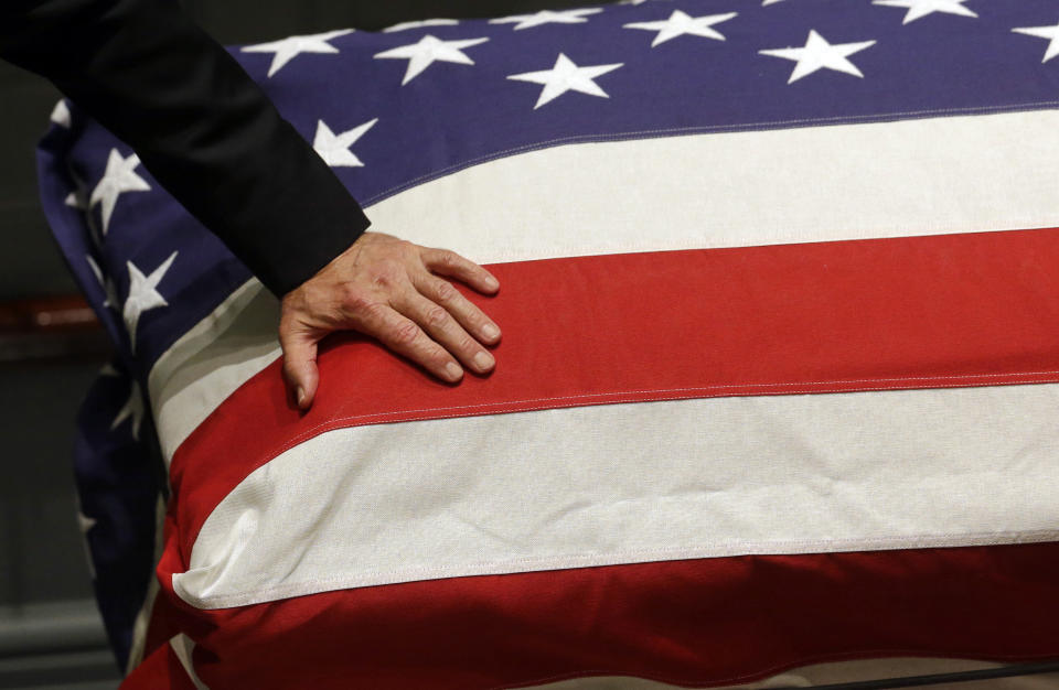 FILE - In this June 4, 2015, file photo, then-Vice President Joe Biden rests his hand on a flag-draped casket containing the remains of his son, former Delaware Attorney General Beau Biden during a visitation at Legislative Hall in Dover, Del. (AP Photo/Patrick Semansky, Pool, File)