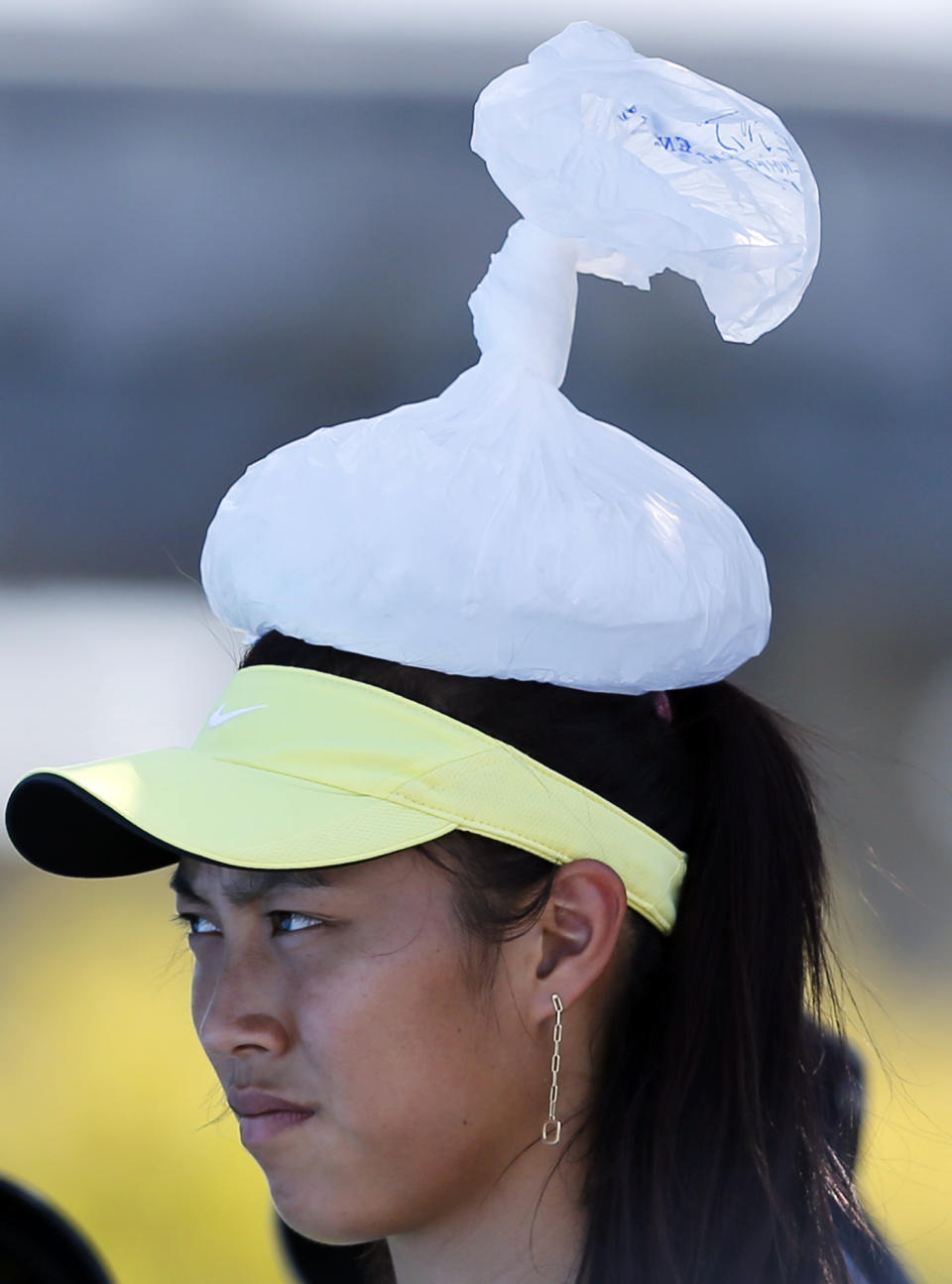 Taiwan's Chan Hao-ching with ice pack on her head, watches the first round match between Christina McHale of the U.S. and Chan Yung-Jan of Taiwan during their first round match at the Australian Open tennis championship in Melbourne, Australia, Tuesday, Jan. 14, 2014. (AP Photo/Shuji Kajiyama)