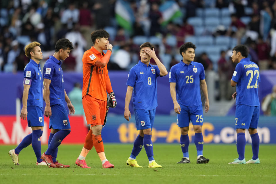 Thailand players are dejected at full time of the Asian Cup round of 16 soccer match between Uzbekistan and Thailand at Al Janoub Stadium in Al Wakrah, Qatar, Tuesday, Jan. 30, 2024. Uzbekistan won 2-1. (AP Photo/Aijaz Rahi)