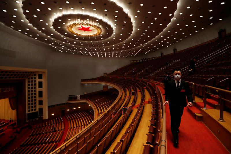 Security personnel inspect the venue at the end of the opening session of NPC in Beijing