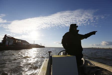 Saxis Island resident and duck decoy carver Grayson Chesser takes to the water off this historic fishing village on Virginia's Eastern Shore, October 25, 2013. REUTERS/Kevin Lamarque