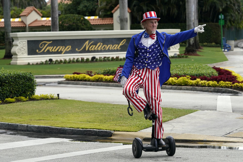 FILE - A man dressed as Uncle Sam waits at a stoplight outside Trump National Doral resort in Doral, Fla., Monday, June 12, 2023. As Trump becomes the first former president to face federal charges that could put him in jail, many Europeans are watching the case closely. But hardly a single world leader has said a word recently about the man leading the race for the Republican party nomination. (AP Photo/Gerald Herbert, File)