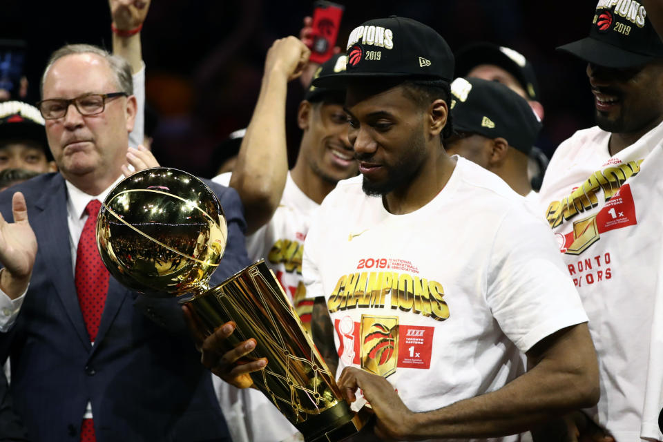 OAKLAND, CALIFORNIA - JUNE 13:  Kawhi Leonard #2 of the Toronto Raptors celebrates with the Larry O'Brien Championship Trophy after his team defeated the Golden State Warriors to win Game Six of the 2019 NBA Finals at ORACLE Arena on June 13, 2019 in Oakland, California. NOTE TO USER: User expressly acknowledges and agrees that, by downloading and or using this photograph, User is consenting to the terms and conditions of the Getty Images License Agreement. (Photo by Ezra Shaw/Getty Images)