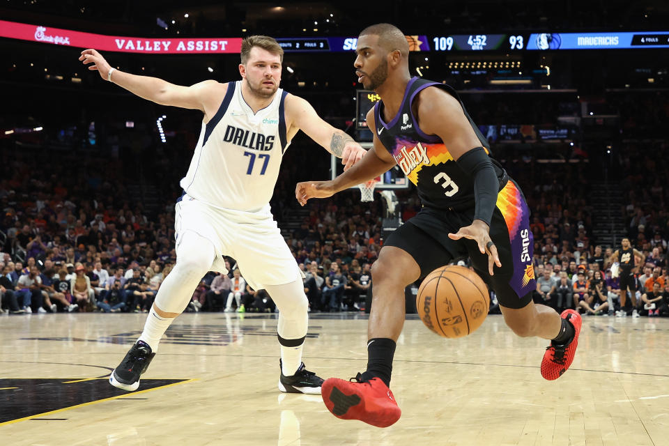 PHOENIX, ARIZONA - MAY 02: Chris Paul #3 of the Phoenix Suns handles the ball against Luka Doncic #77 of the Dallas Mavericks during the second half of Game One of the Western Conference Second Round NBA Playoffs at Footprint Center on May 02, 2022 in Phoenix, Arizona.  The Suns defeated the Mavericks 121-114. NOTE TO USER: User expressly acknowledges and agrees that, by downloading and or using this photograph, User is consenting to the terms and conditions of the Getty Images License Agreement. (Photo by Christian Petersen/Getty Images)