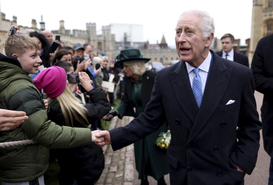 FILE - Britain's King Charles III and Queen Camilla greet people after attending the Easter Matins Service at St. George's Chapel, Windsor Castle, England, March 31, 2024. King Charles III is on the comeback trail. The 75-year-old British monarch will slowly ease back into public life after a three-month break to focus on his treatment and recuperation after he was diagnosed with an undisclosed type of cancer. (Hollie Adams/Pool Photo via AP, File)