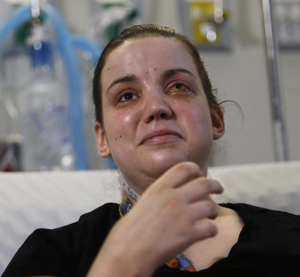 Washington mudslide survivor Amanda Skorjanc, 25, talks to the media while sitting in her hospital bed on Wednesday, April 9, 2014, in Seattle. On March 22, Skorjanic said she was trapped in a pocket formed by her broken couch and pieces of her roof. Skorjanic said that she remembers hearing the voices of several men coming to her aid, she had two broken legs and a broken arm. (AP Photo/The Herald, Dan Bates, Pool)